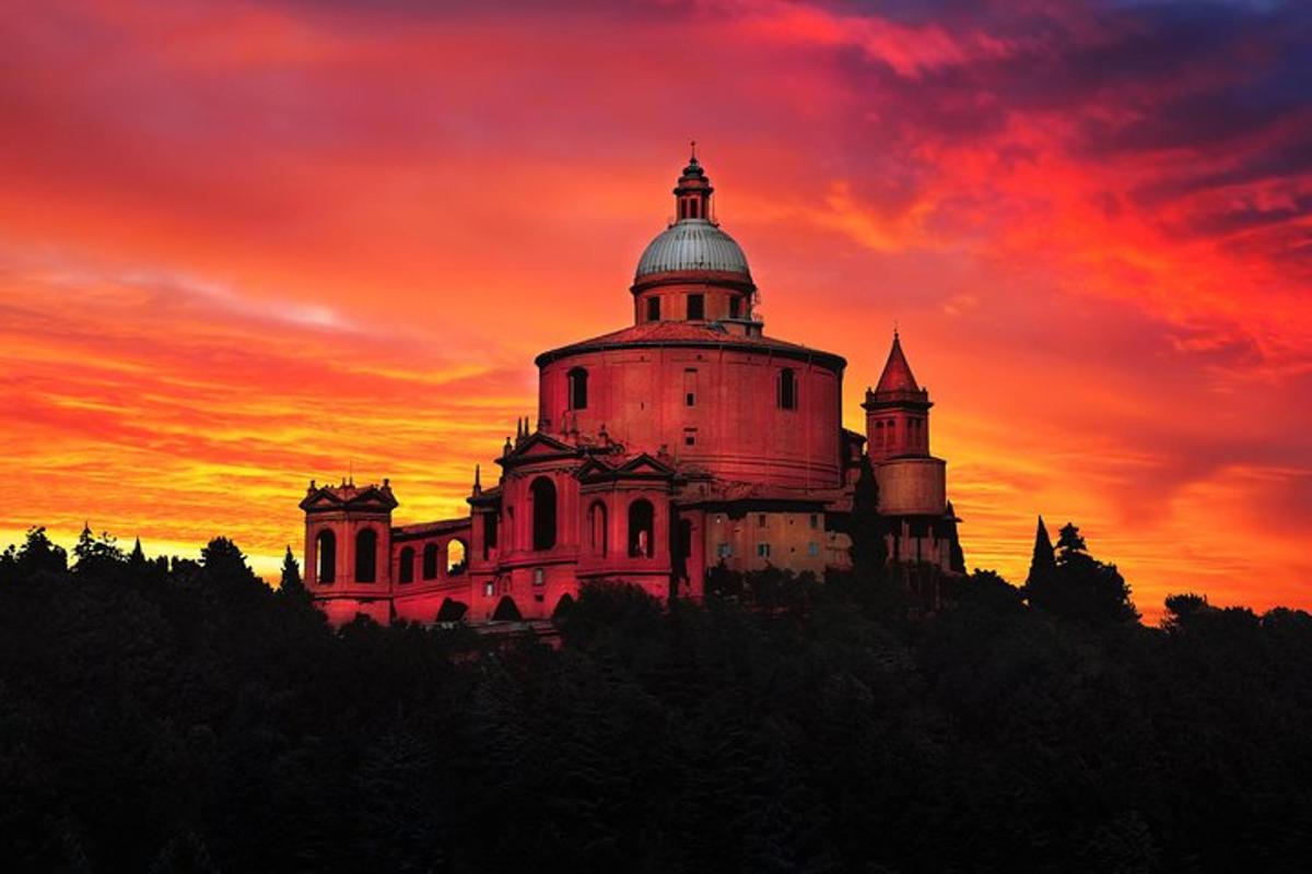 a castle on a hill with a sunset in the background