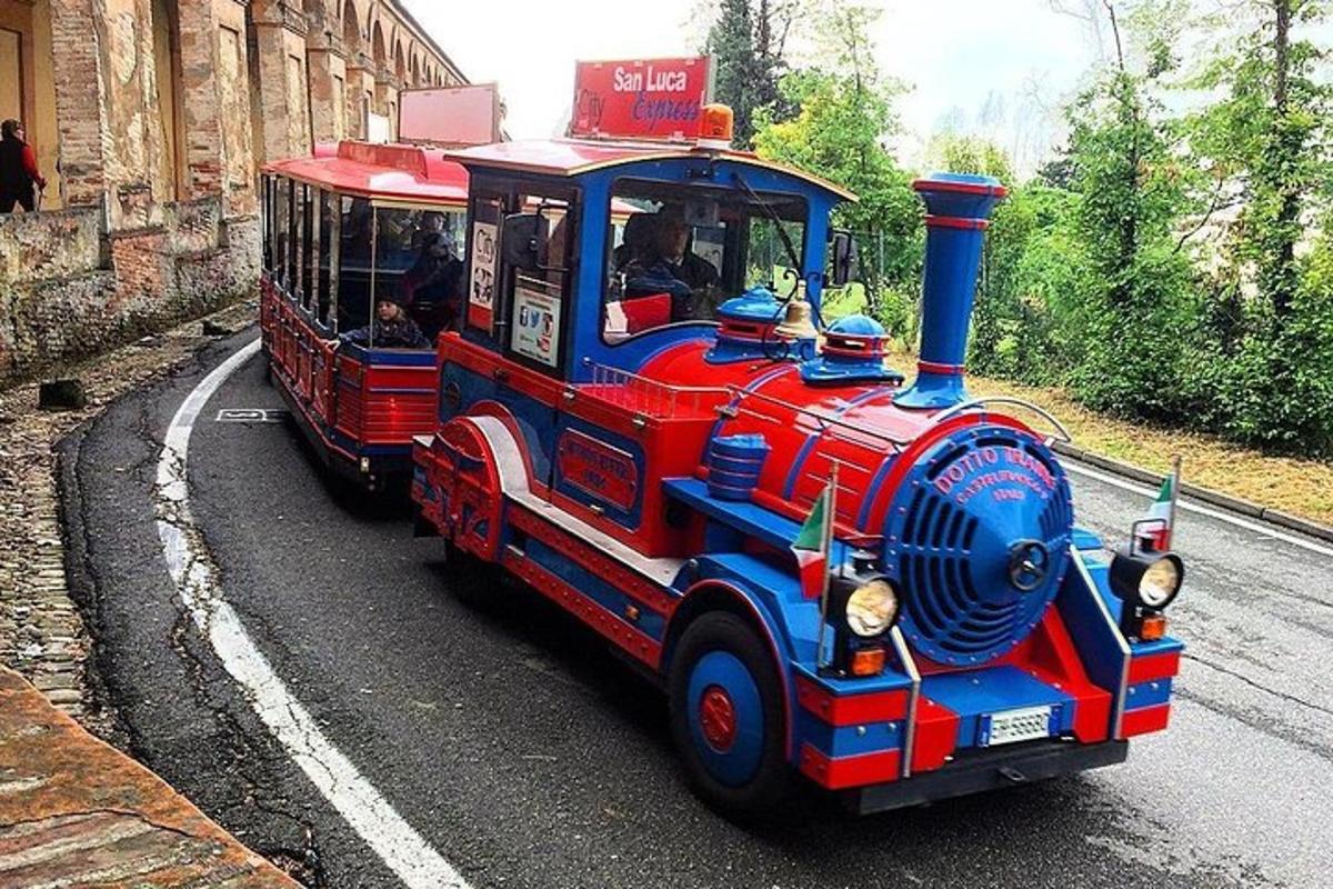 a small red and blue train on a road