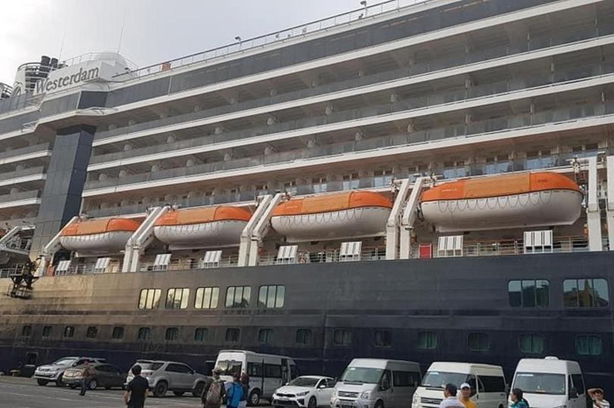kapal pesiar dengan mobil-mobil terparkir di depannya
