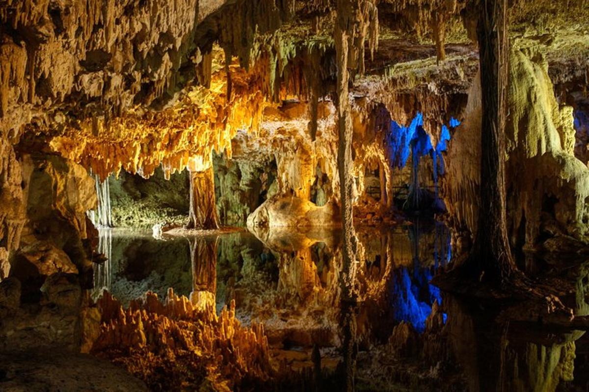 a cave with a rock wall and water in it