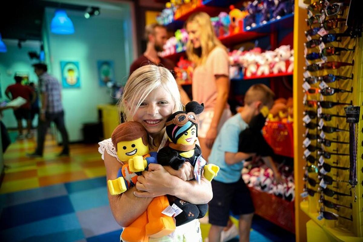 a woman holding two stuffed animals in a store