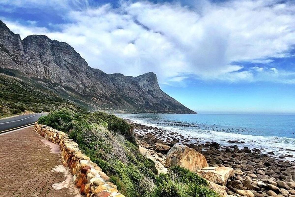 a road next to a beach with a mountain