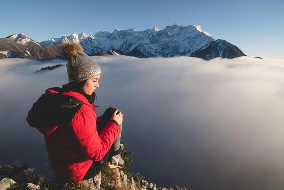 a woman sitting on top of a mountain