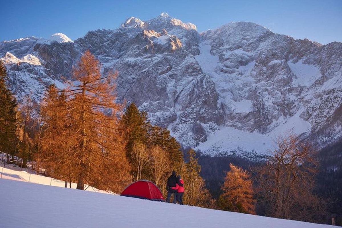 a person standing on top of a snow covered mountain