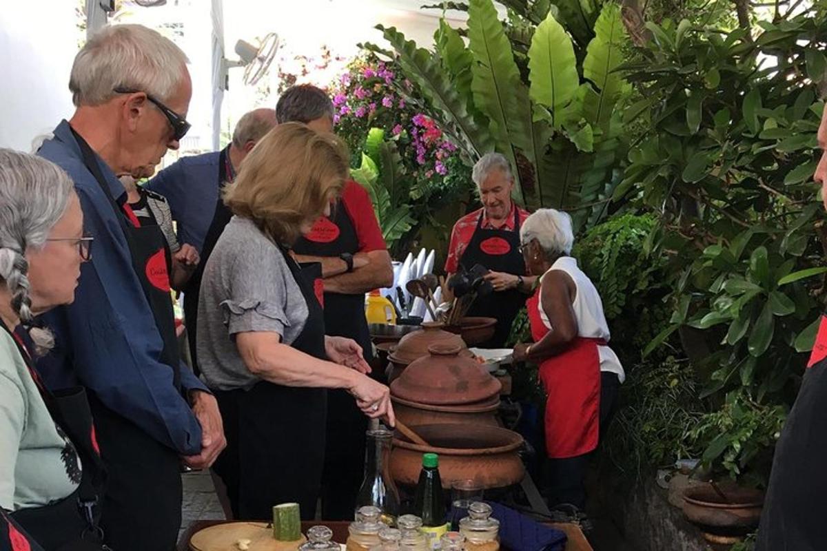 a group of people standing around a table in a garden
