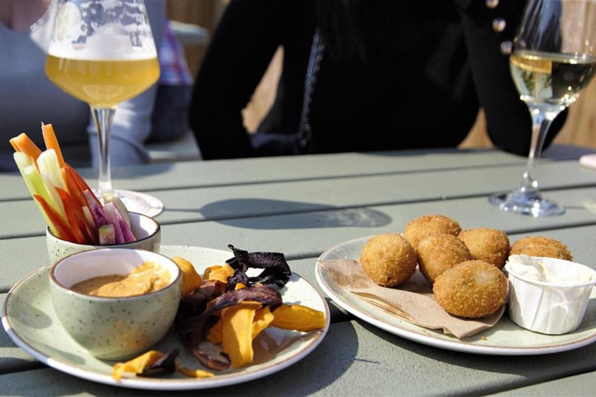 a table with two plates of food and a glass of wine