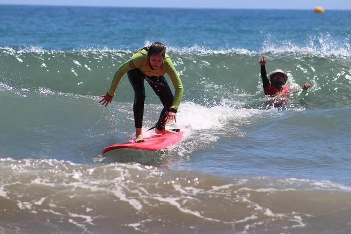 due persone cavalcano un'onda su tavole da surf nell'oceano