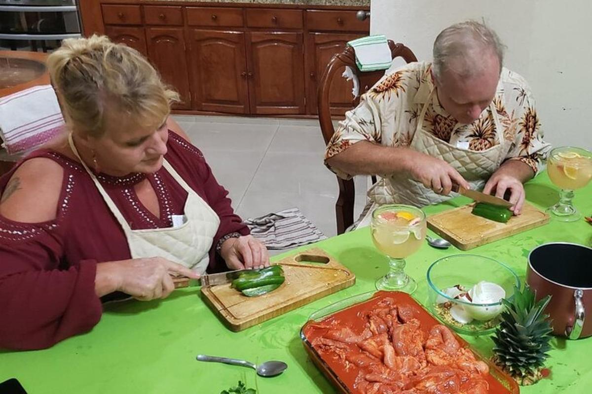 due persone sedute a un tavolo che preparano il cibo