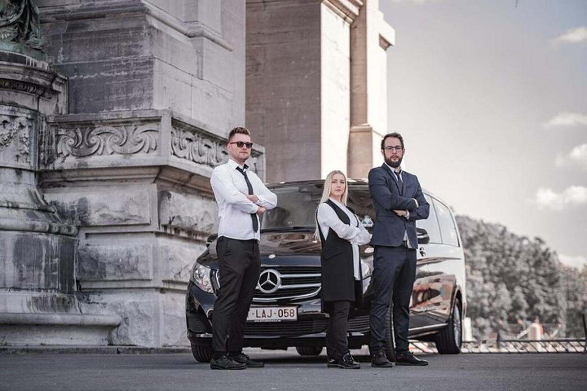 two men and a woman standing in front of a car