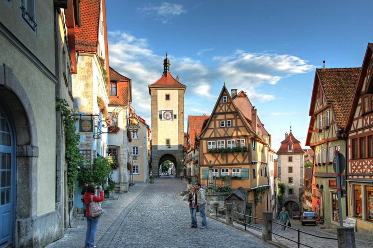 a group of people walking down a street in a town