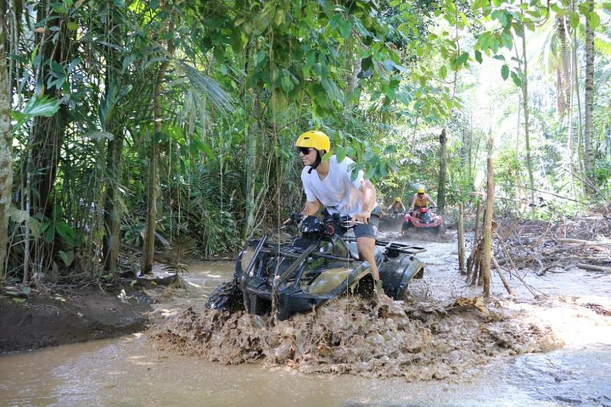 a man riding a dirt bike in the jungle
