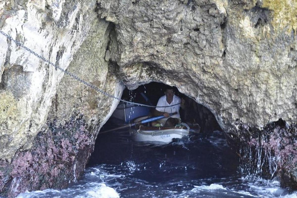 a man in a boat in a cave in the water