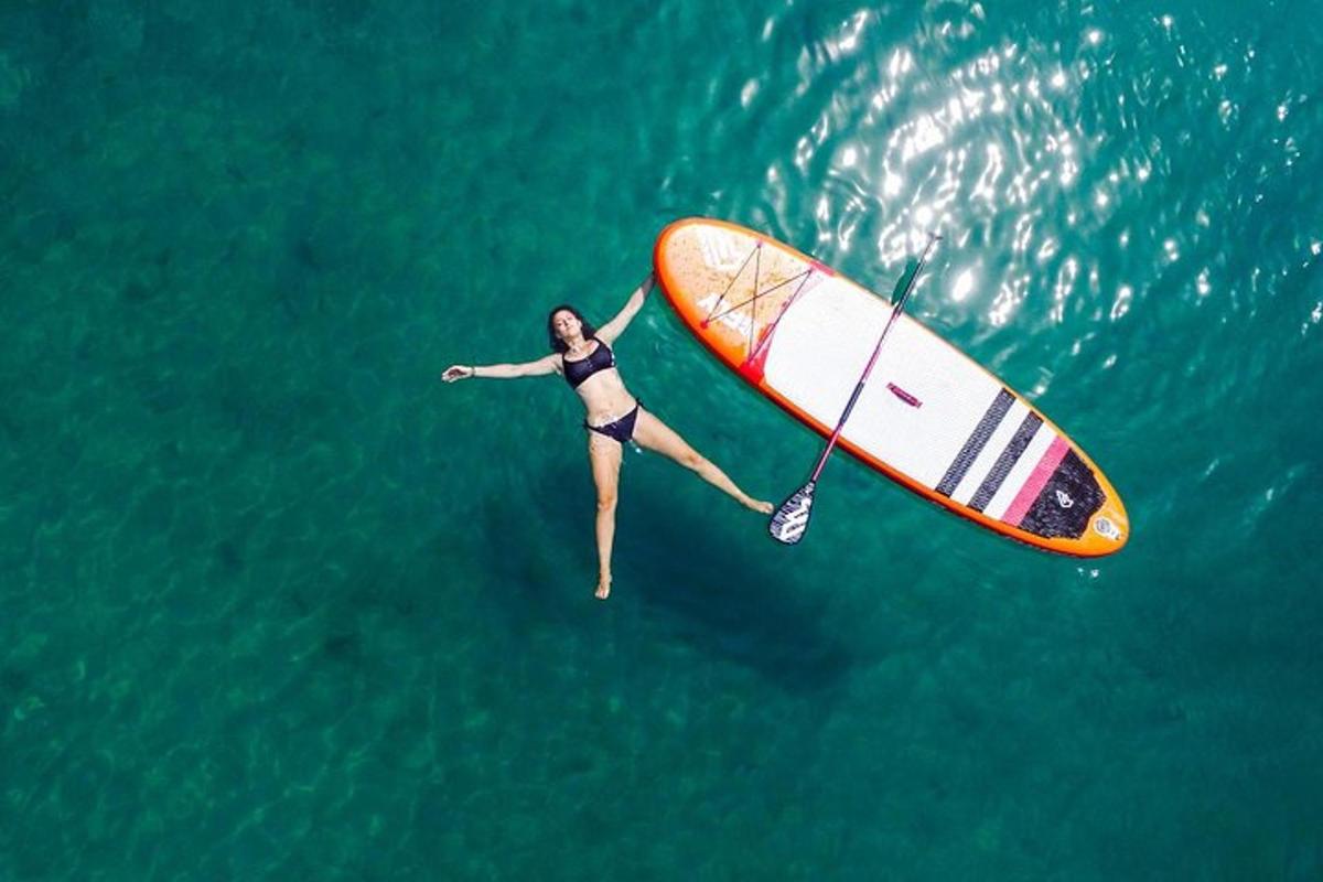 una dona està sobre una taula de surf a l'aigua