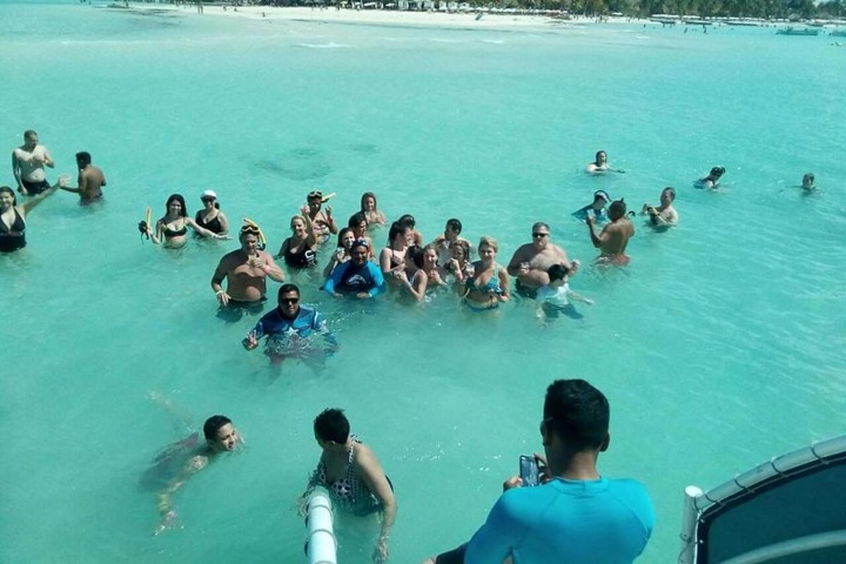 a group of people in the water at a beach