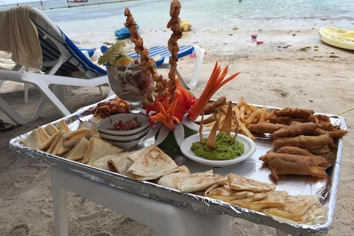 a tray of food on a table on the beach