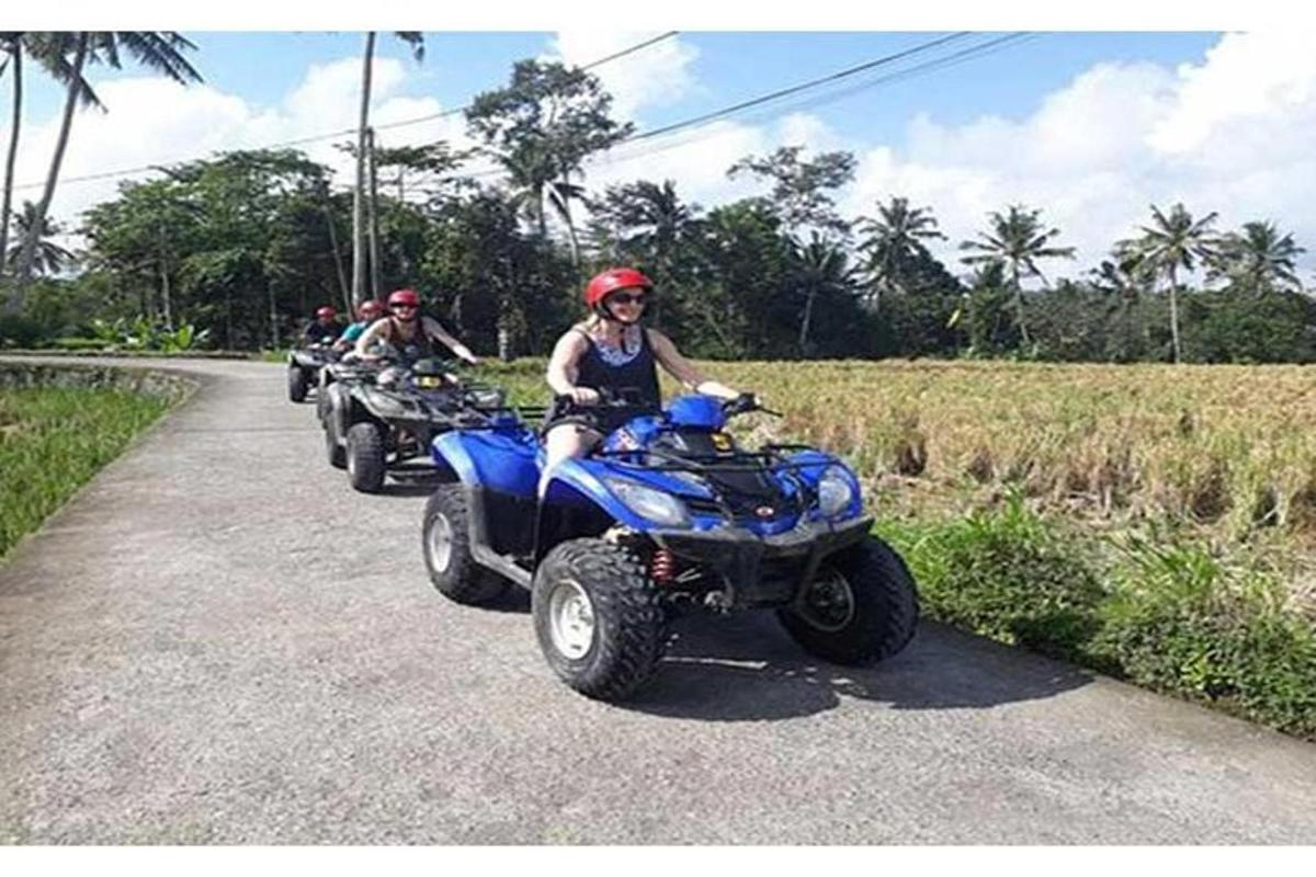a woman sitting on a four wheeler on a road