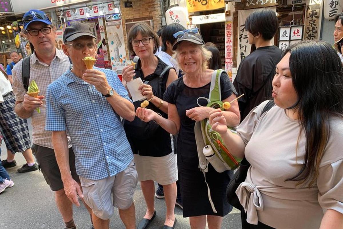 a group of people standing on a street eating food