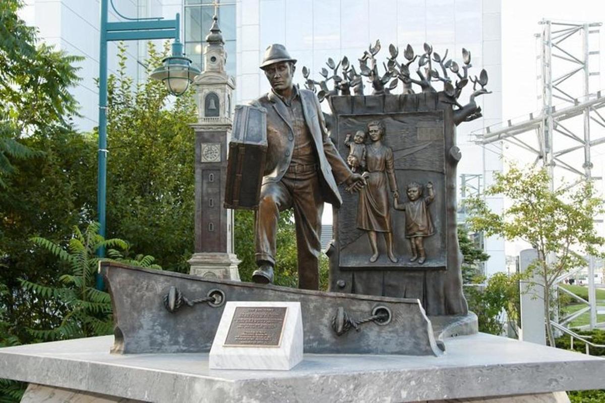 a statue of a man standing next to a clock