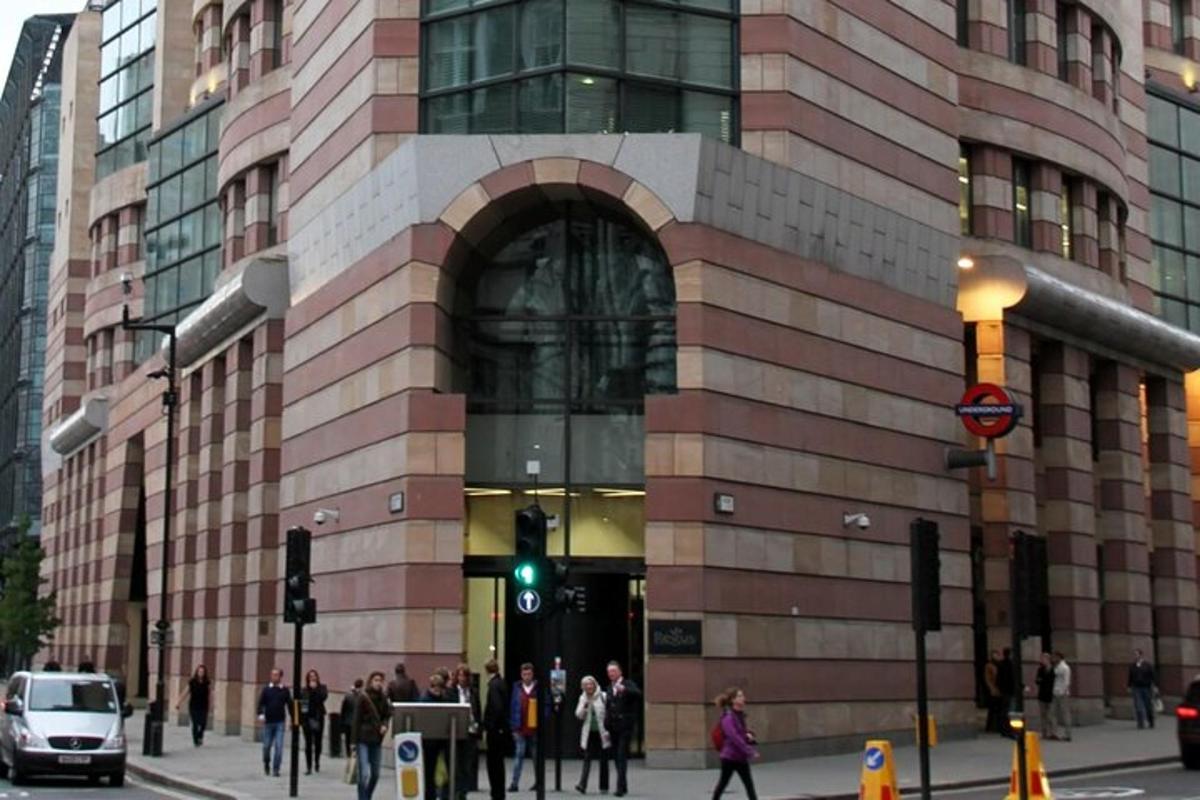 a crowd of people walking in front of a building