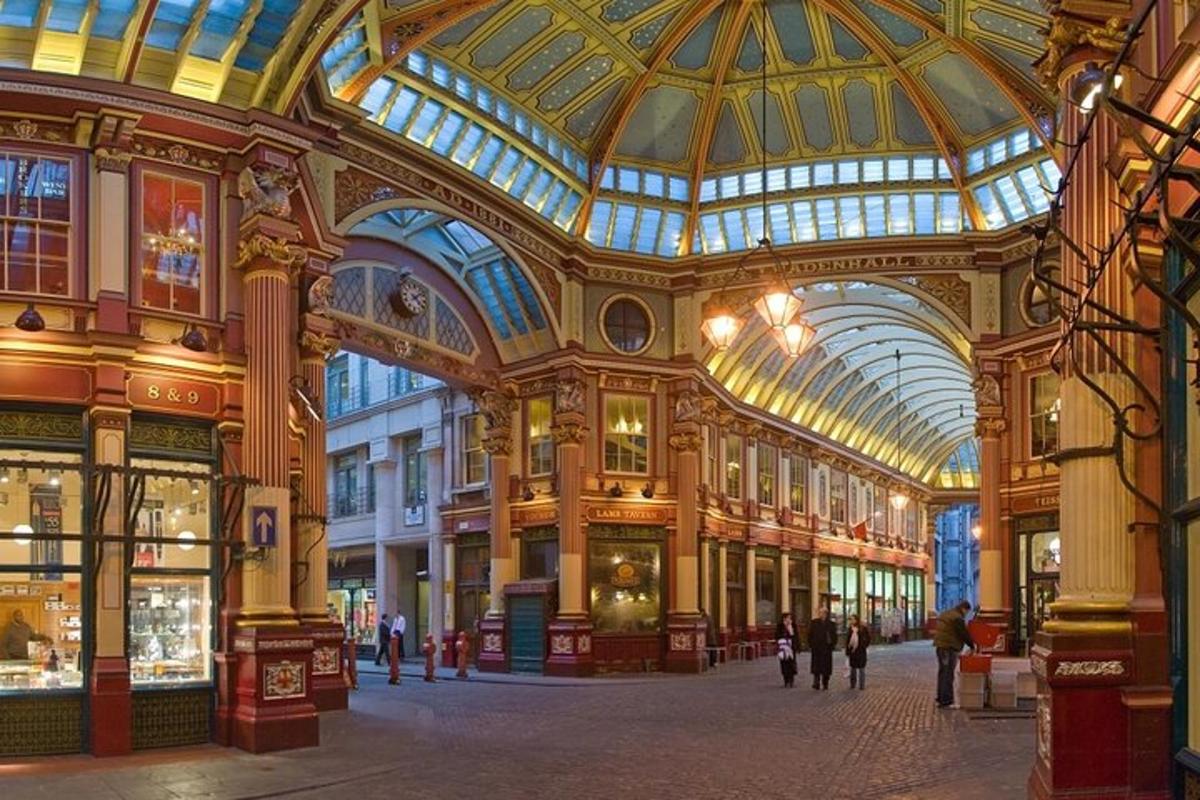 a large building with a domed ceiling with people walking in it