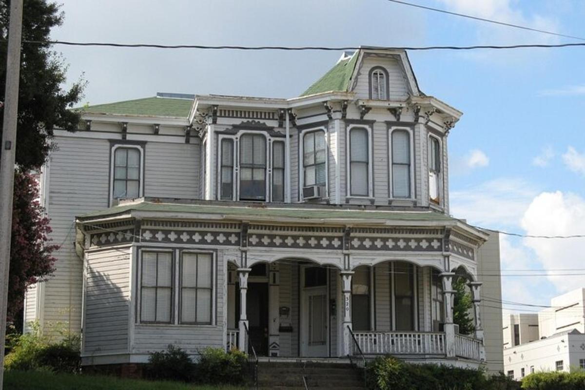 an old house with a porch on a street
