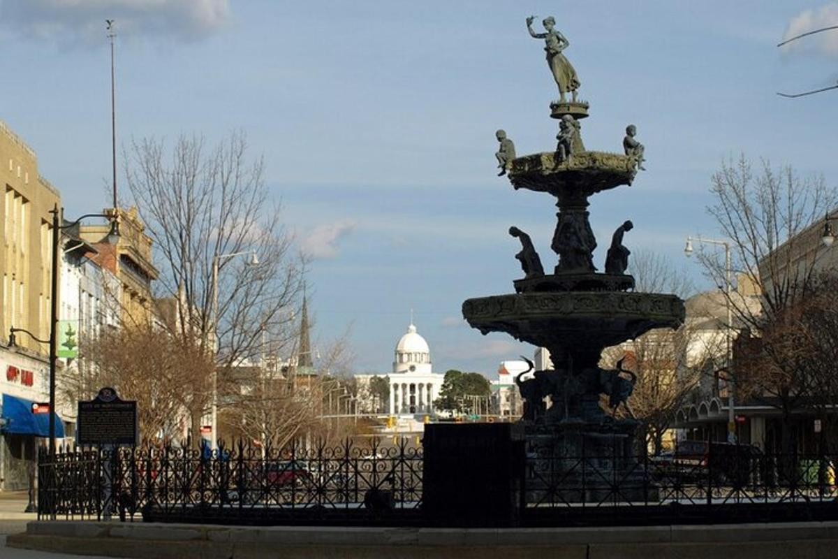 a fountain in the middle of a city with a building