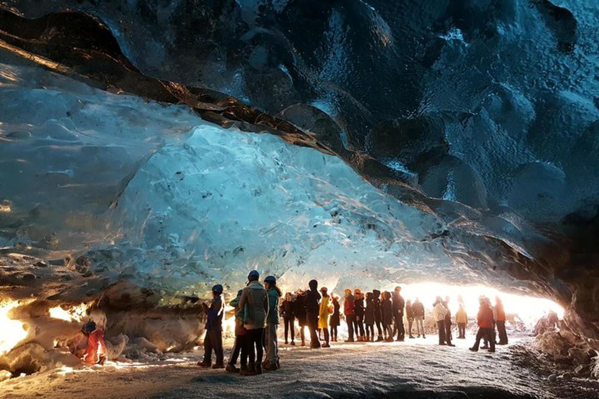 a group of people standing inside of an ice cave
