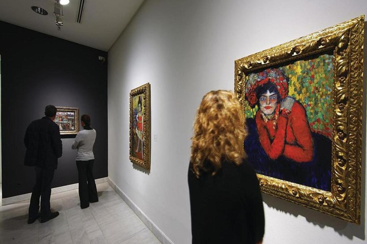 a group of people looking at a painting in a museum