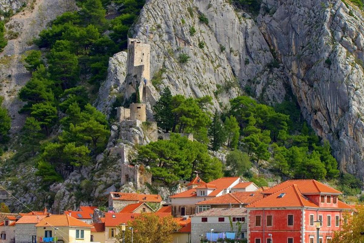 a town with a castle on the side of a mountain