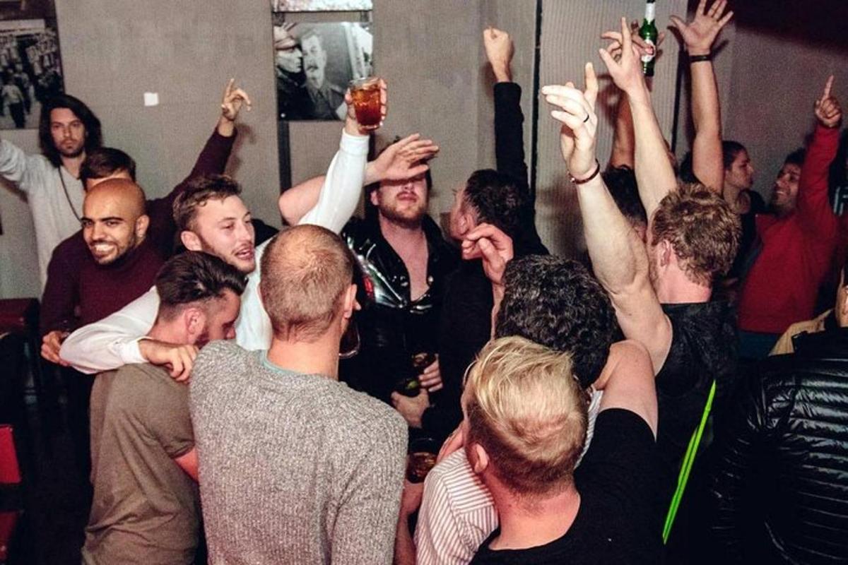 a group of people with their arms in the air