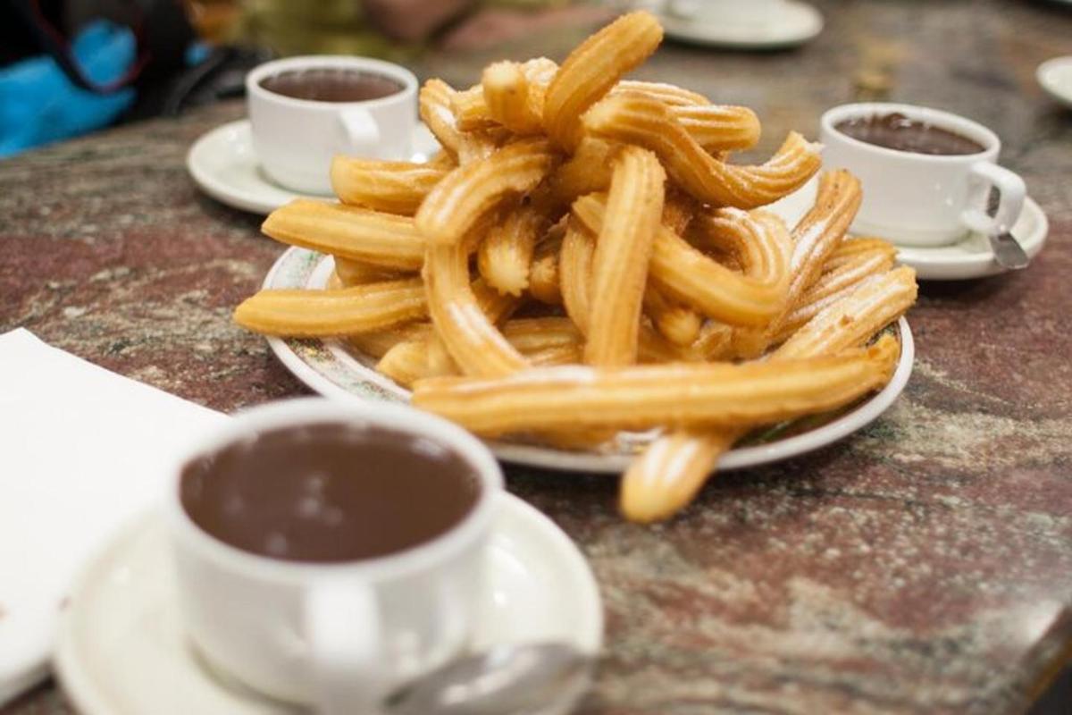 um prato de batatas fritas em uma mesa com café