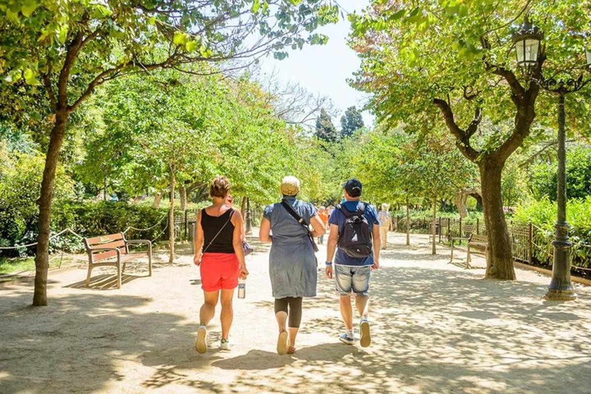 três pessoas caminhando por um caminho em um parque