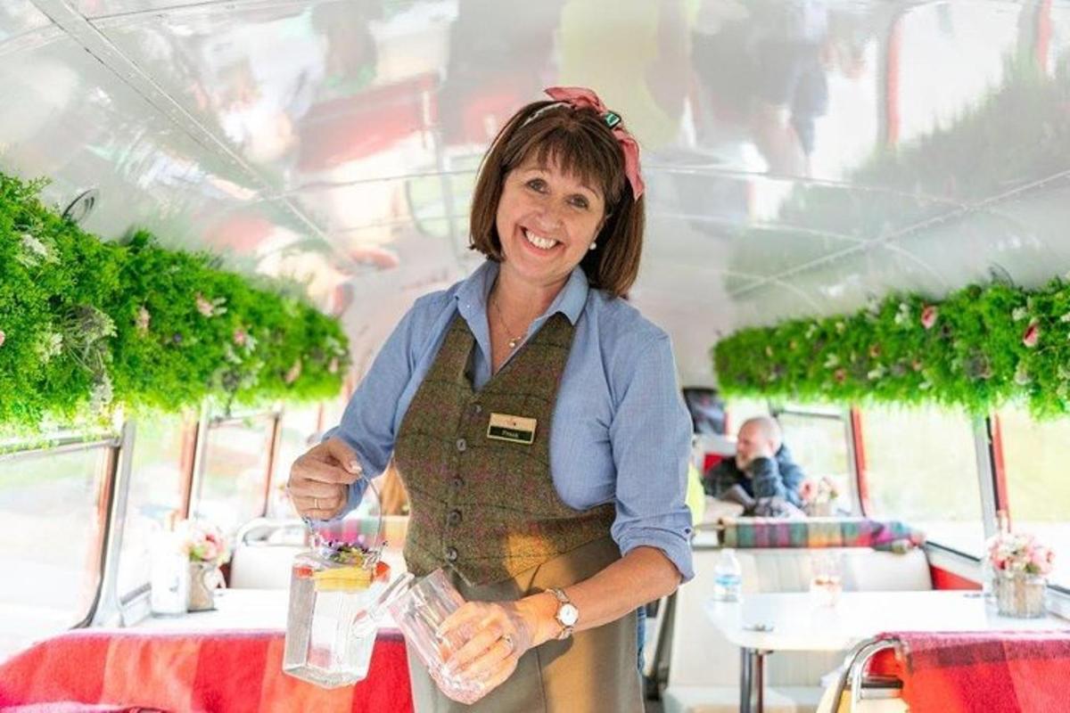 a woman is standing at a table in a restaurant