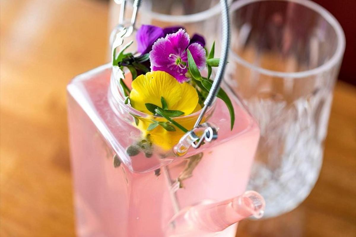a person holding a vase with flowers in it