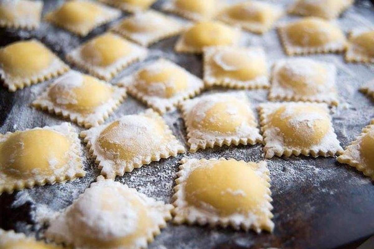 a bunch of pastries on a baking sheet with powdered sugar