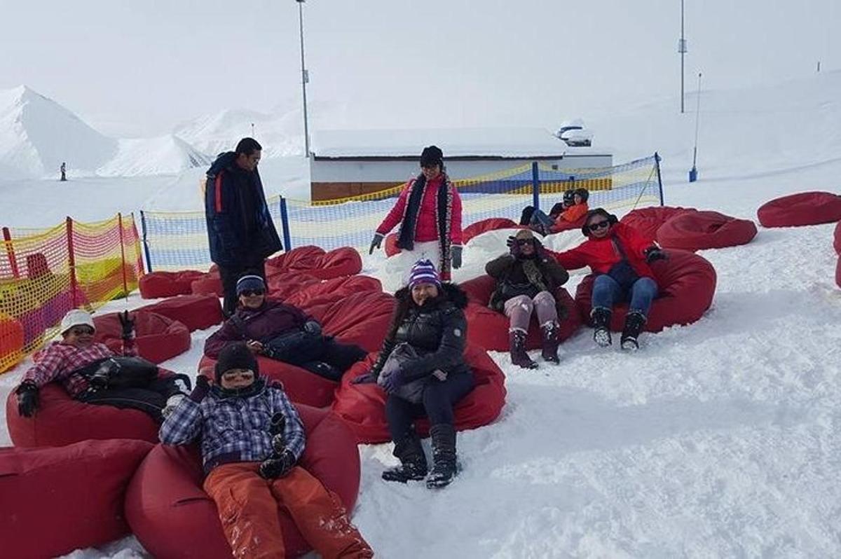 a group of people sitting on a bean bag chairs in the snow