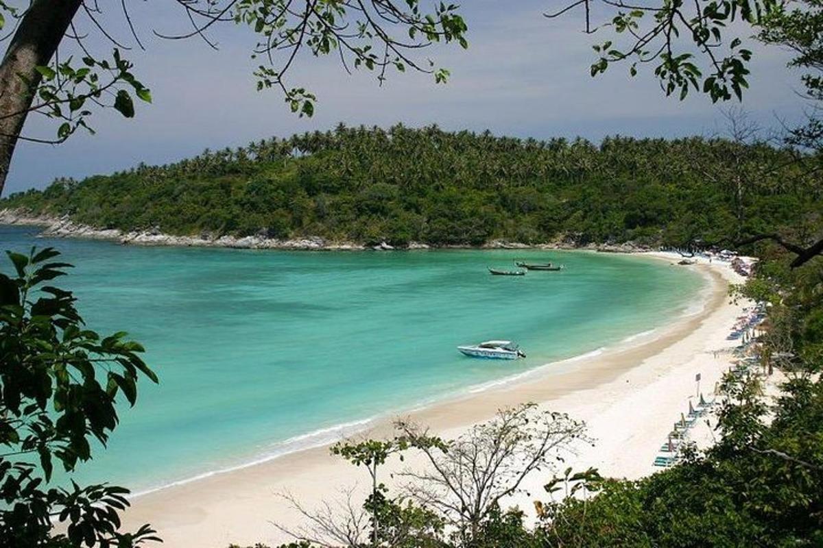 a beach with two boats in the water