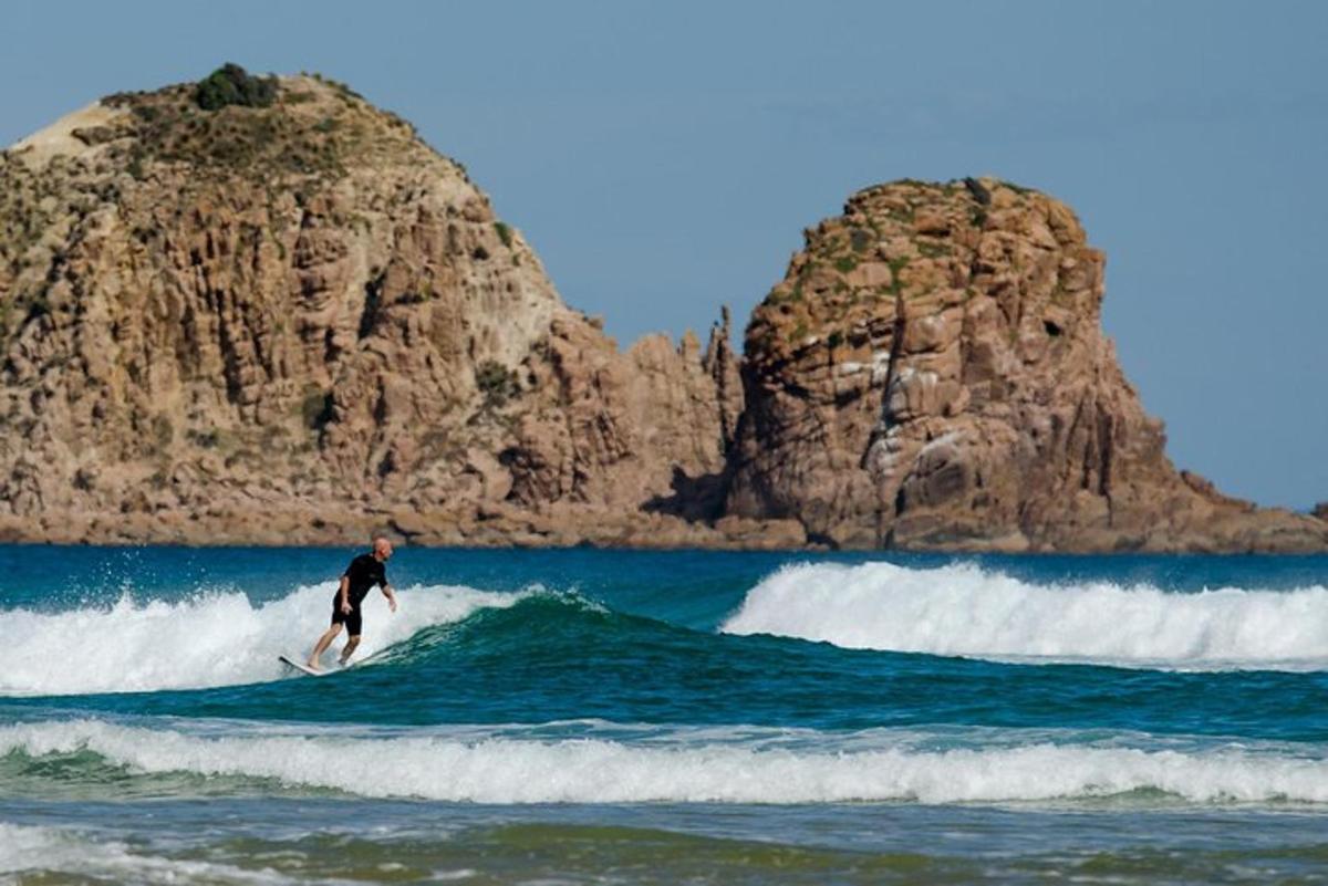 a man riding a wave on a surfboard in the ocean