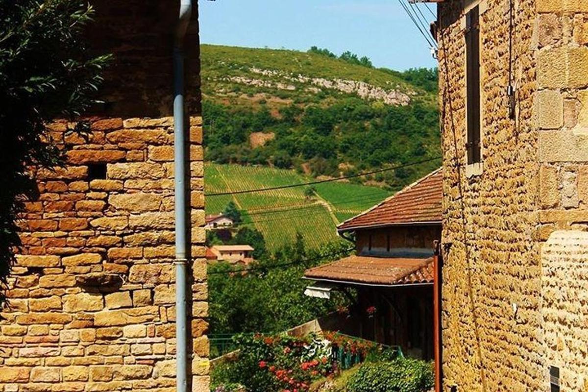 a stone building with a hill in the background
