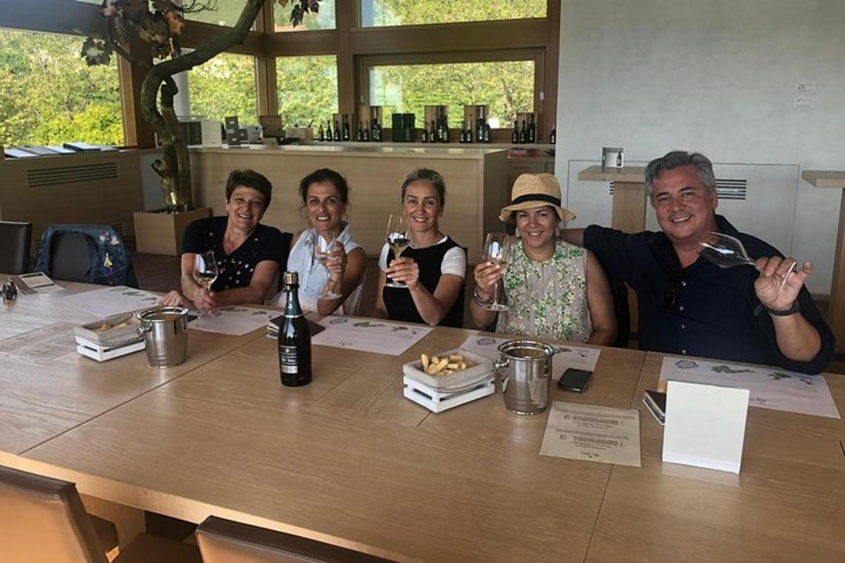 a group of people sitting around a table with wine glasses