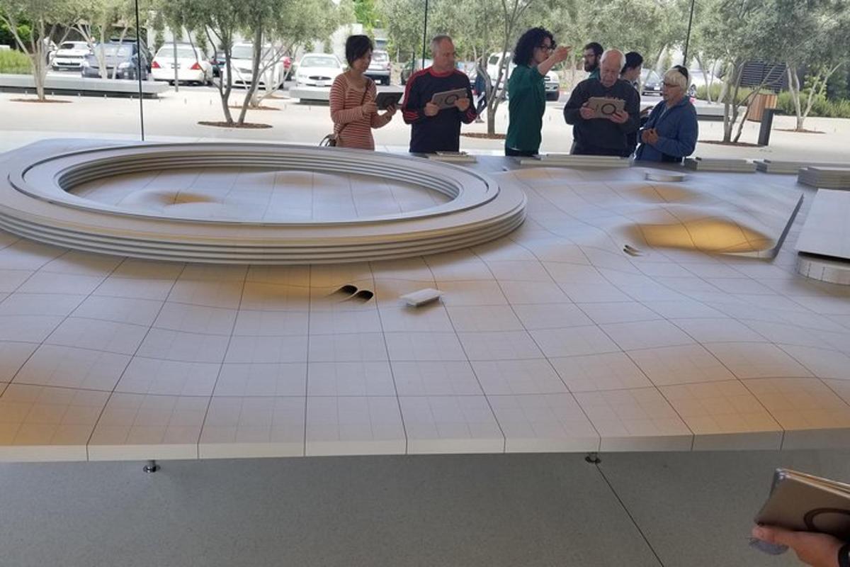 a group of people standing around a circle on a tile floor