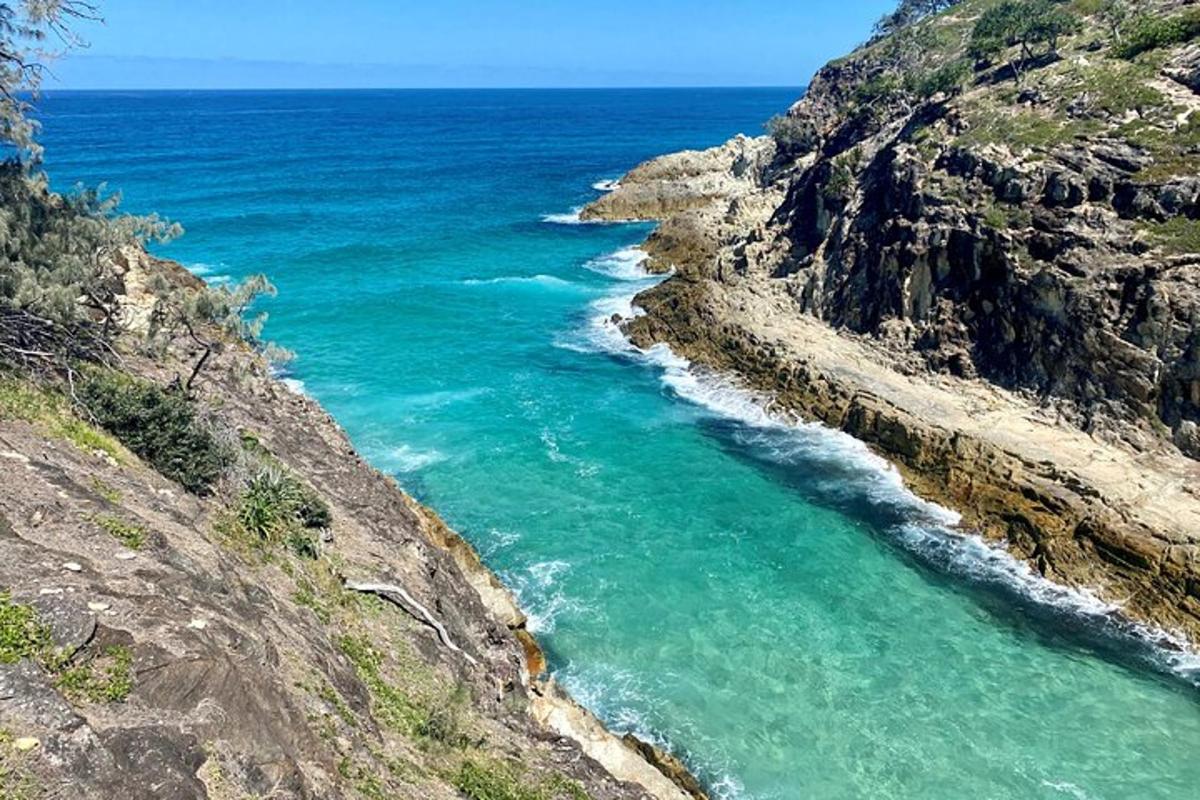 an aerial view of the ocean on a cliff