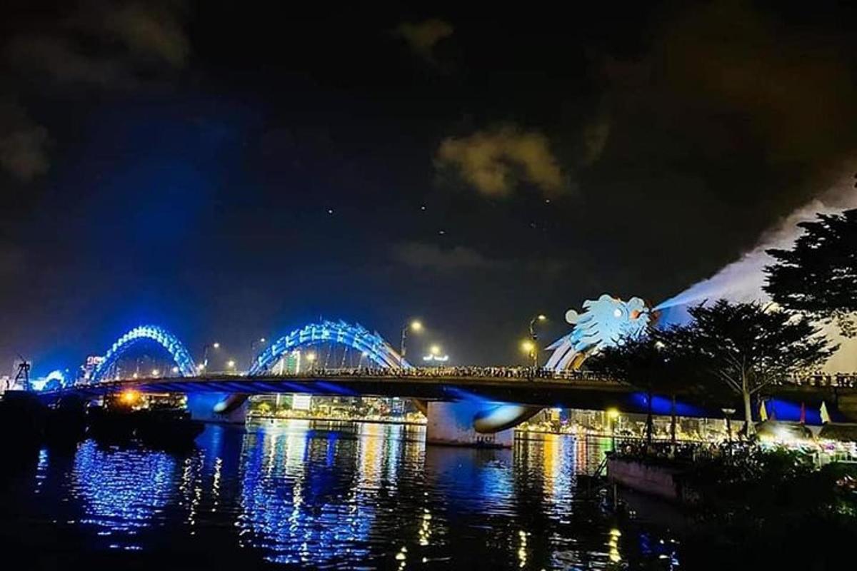a bridge over a river at night with blue lights