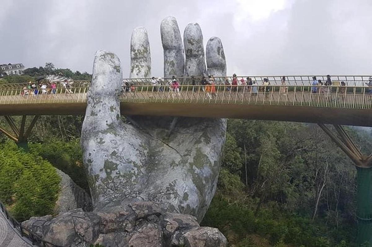 statuja, kurā attēlota roka, kas tur tiltu