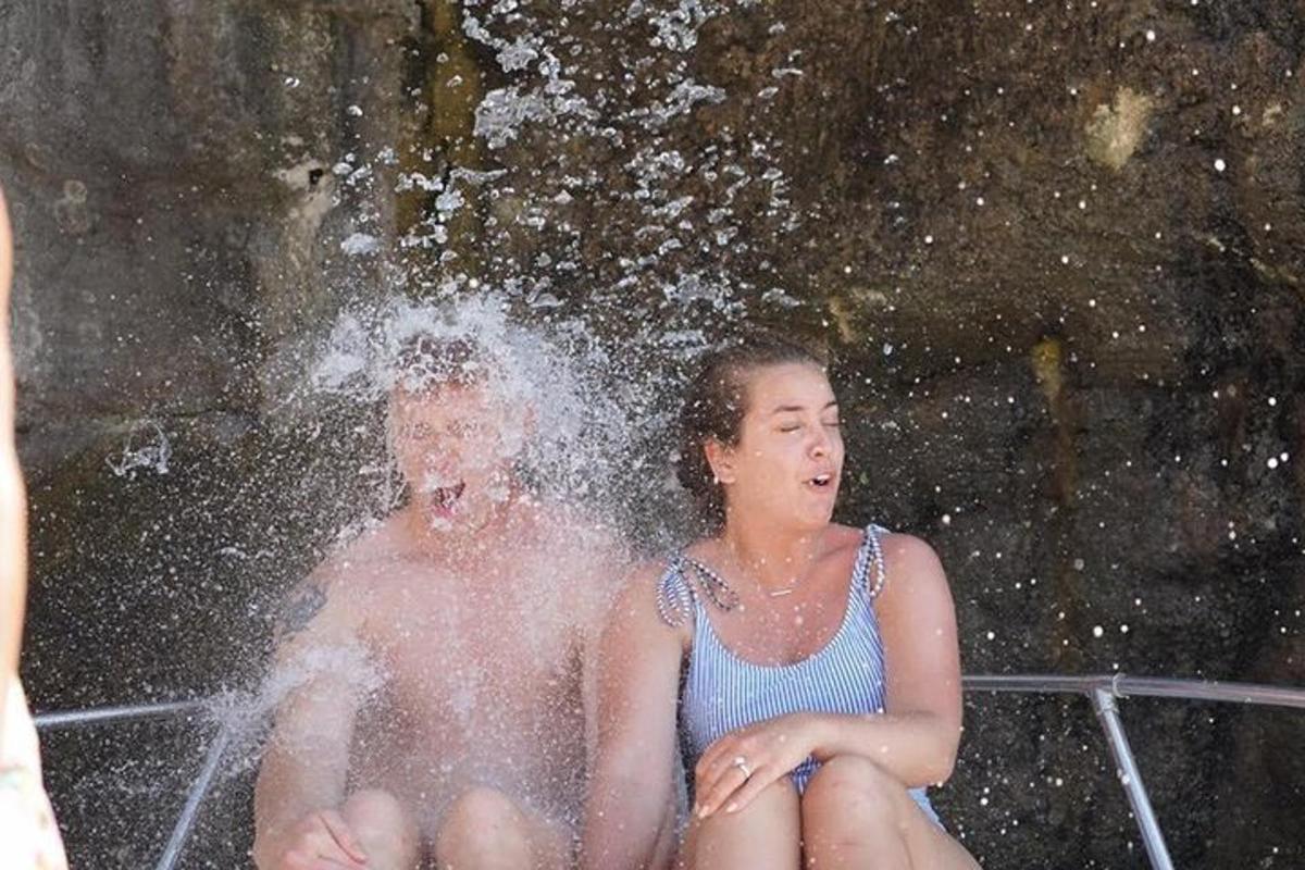 a man and a woman sitting in a fountain