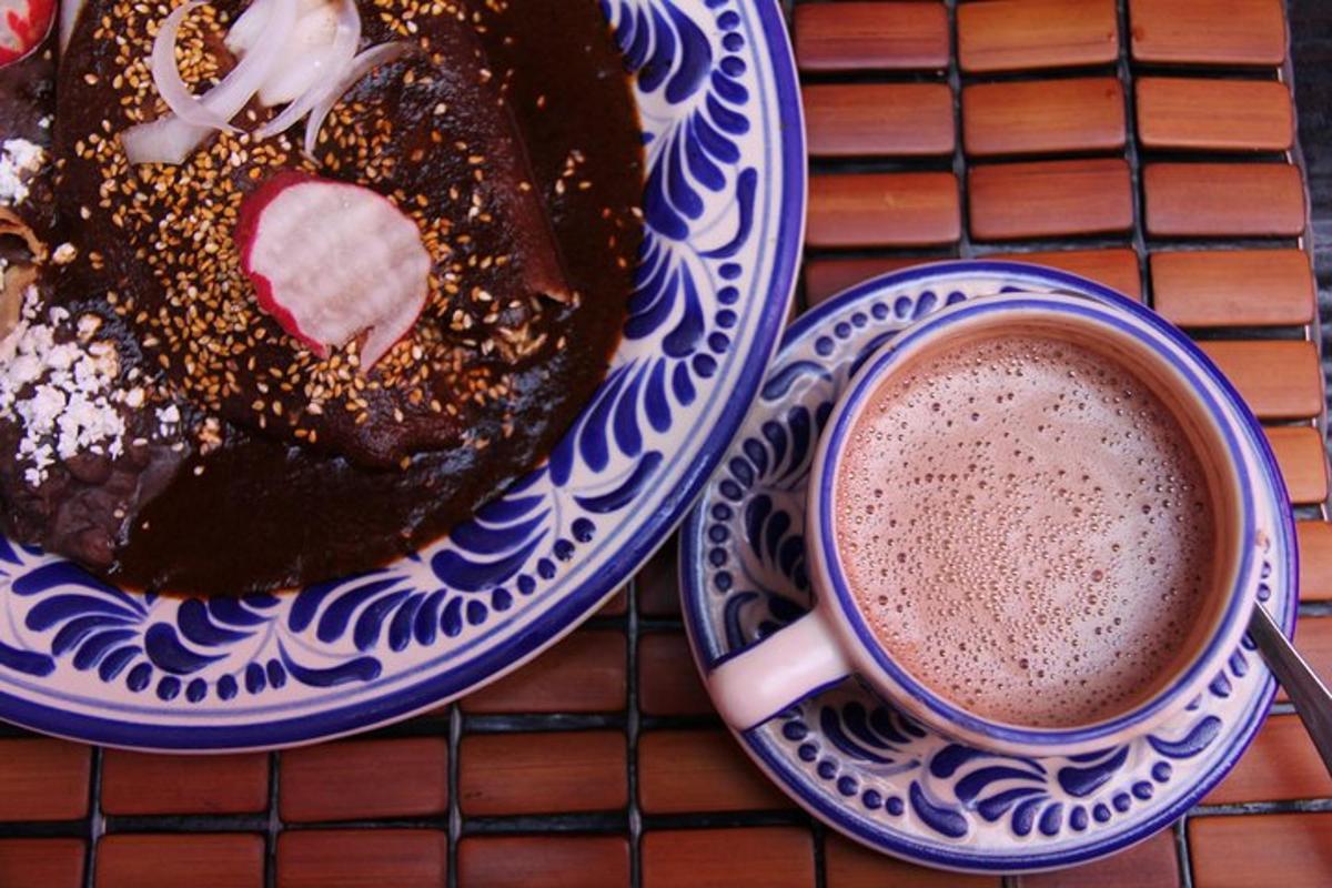 a plate with a chocolate doughnut and a cup of coffee
