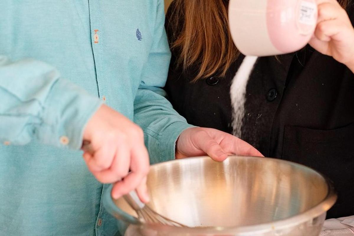 a woman mixing ingredients in a metal bowl