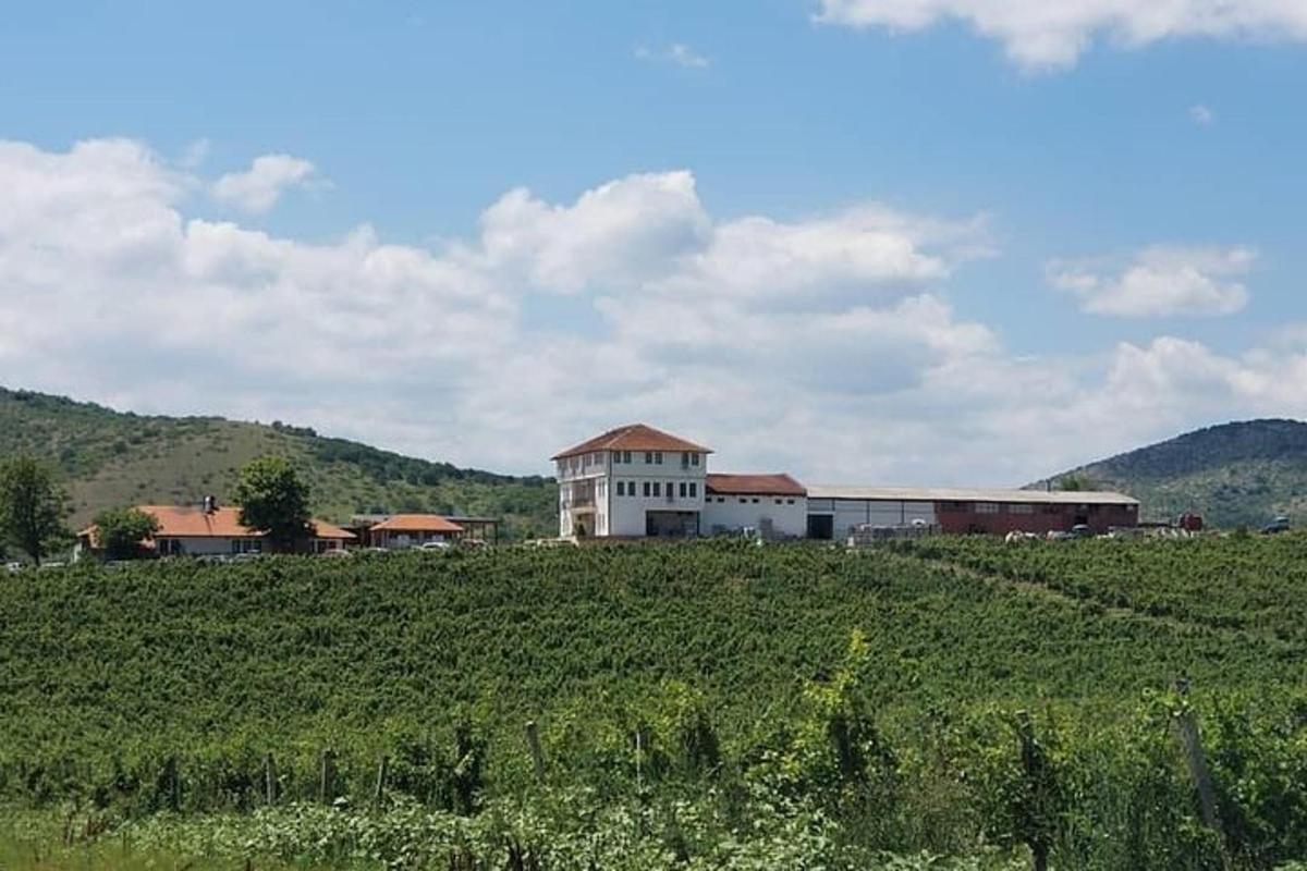 a building in the middle of a field of crops
