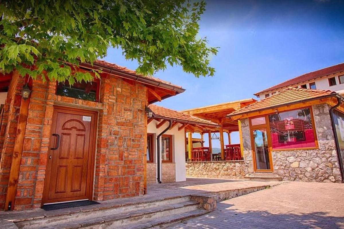 a brick house with a wooden door and a porch