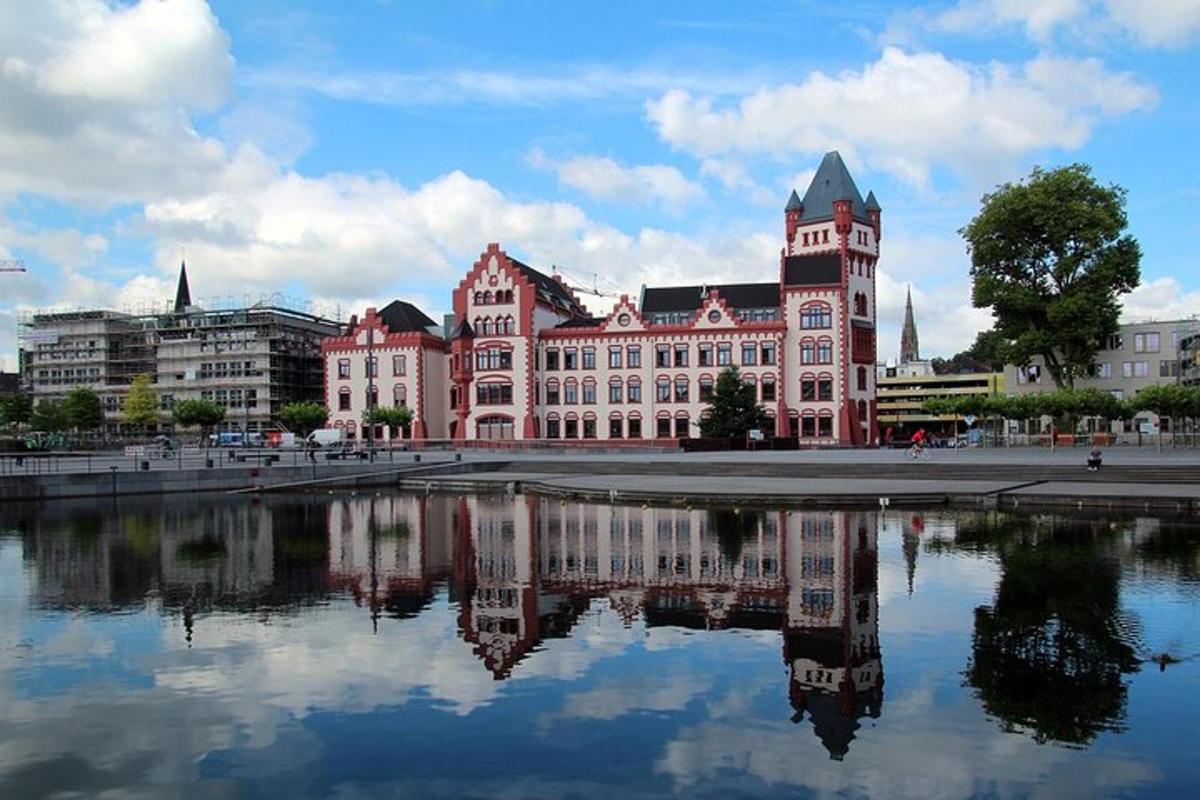 a large building with a reflection in a body of water